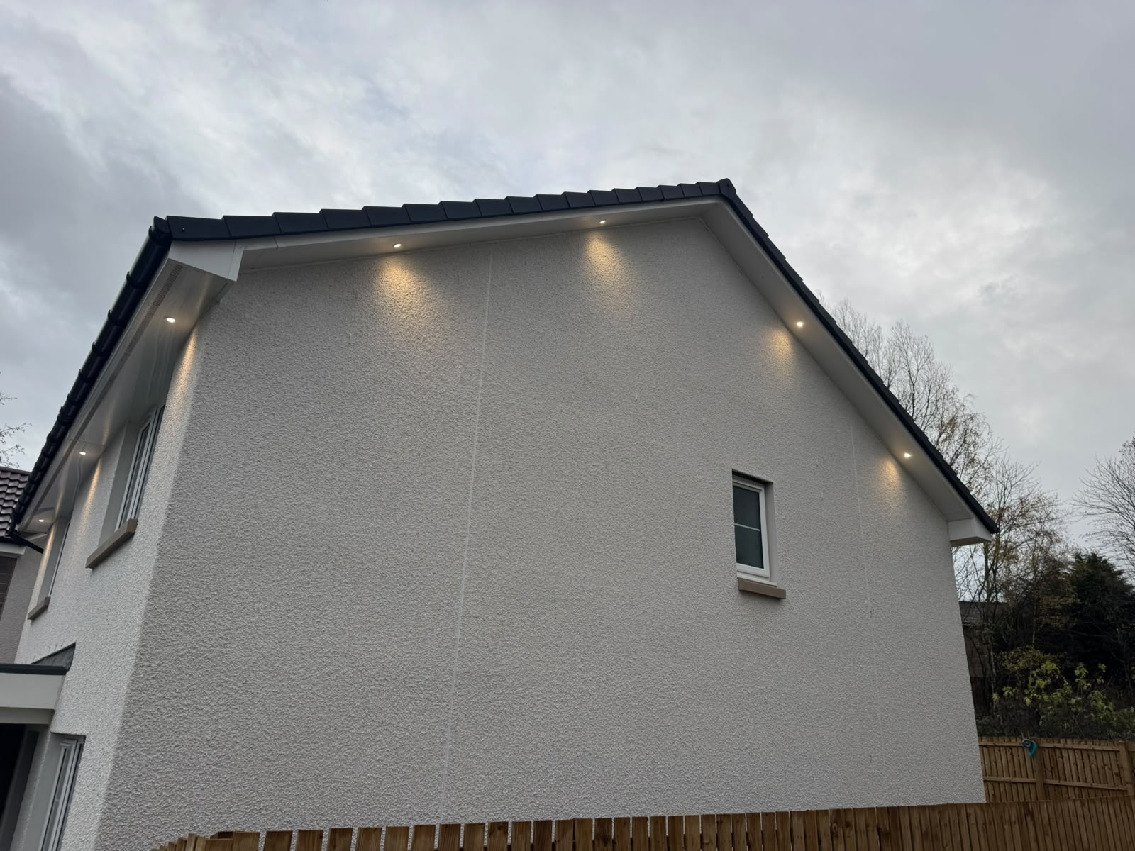 Soffit lighting installation by Electrust — LED downlights under the eaves of a Scottish home