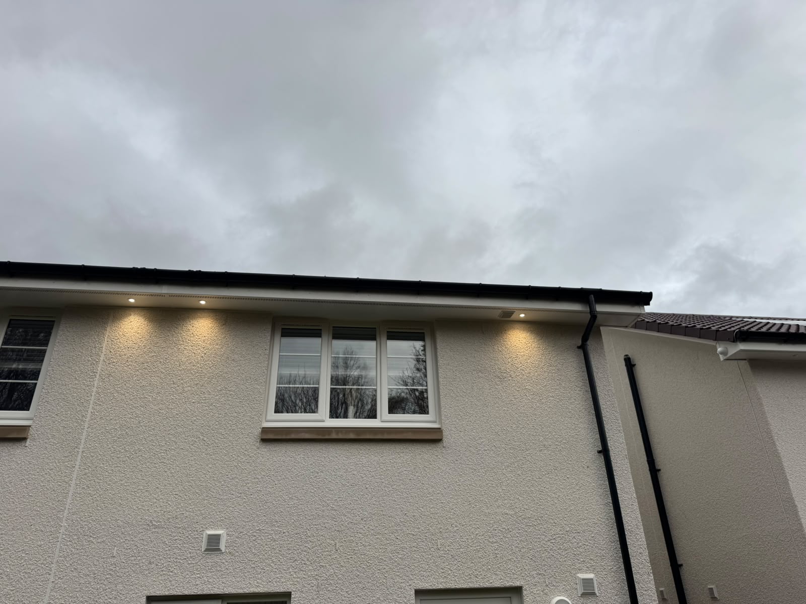 Soffit lighting installation by Electrust — LED downlights under the eaves of a Scottish home