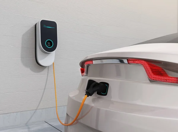 Wall-mounted home EV charger connected to a car on a driveway